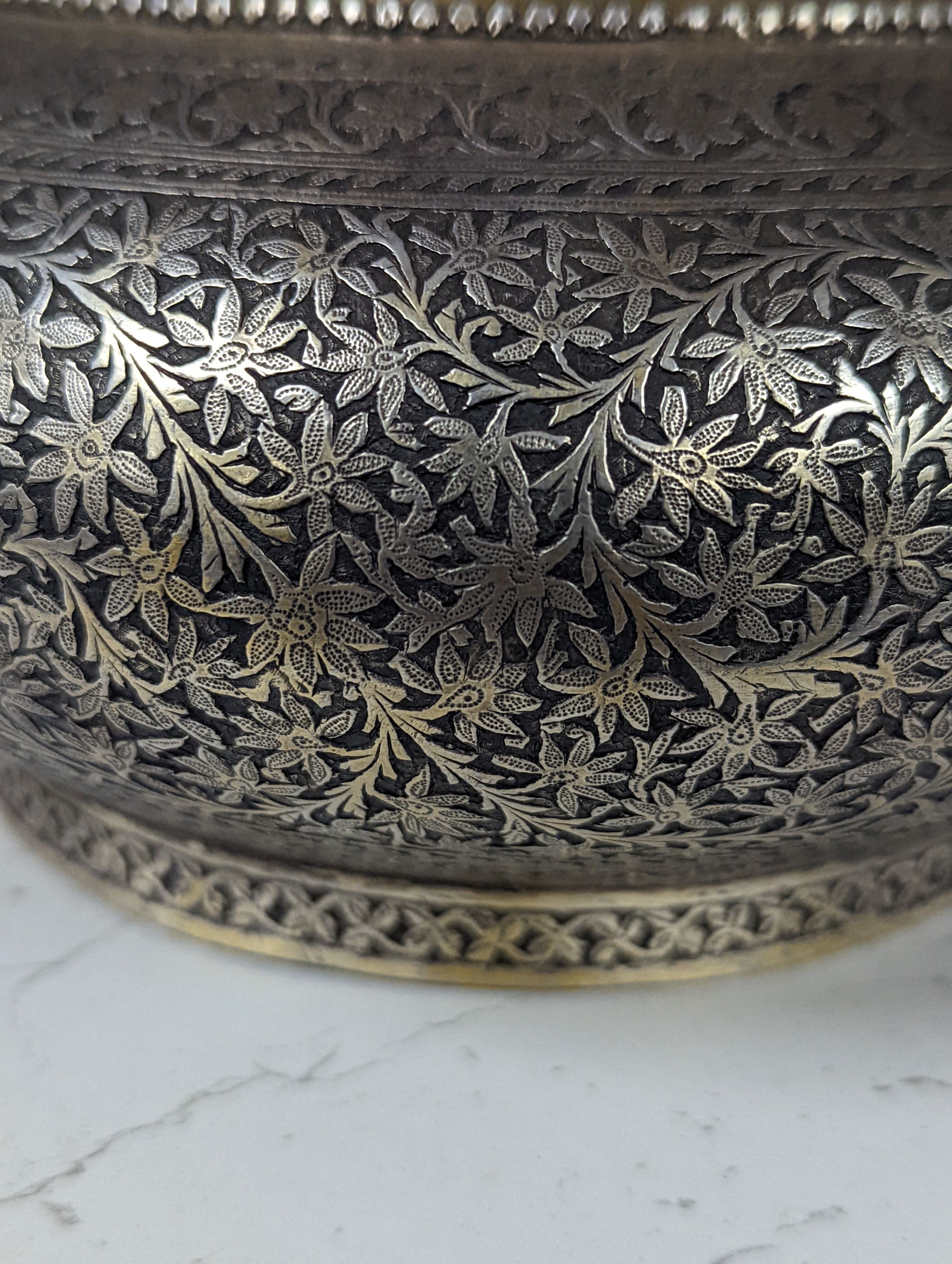 A 19th century North Indian silver surahi with engraved shawl decoration 30cm